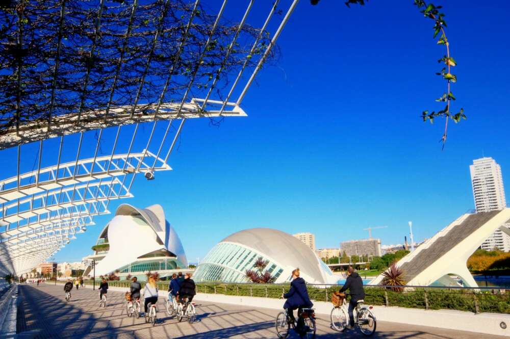 Palau de les Arts i les Ciències de Valencia mientras gente van con bicicleta