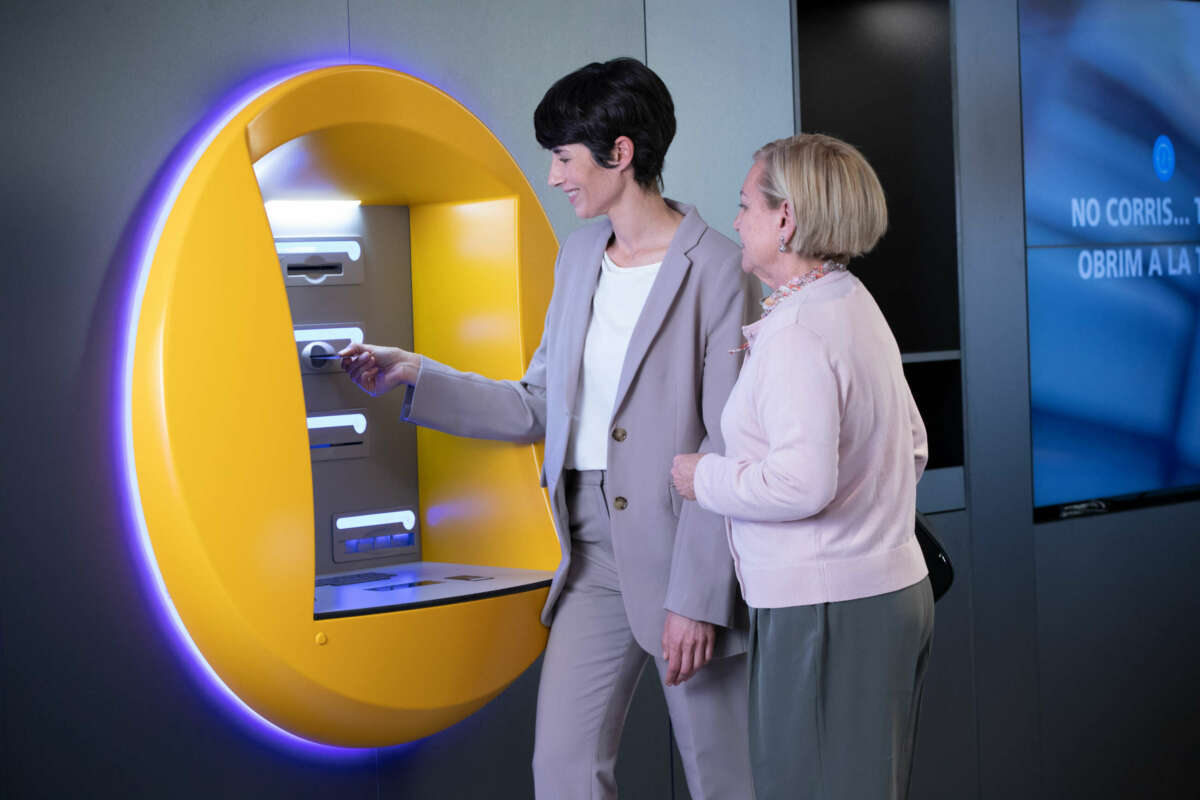 Una mujer mayor y una empleada de Caixabank. Foto: Caixabank.